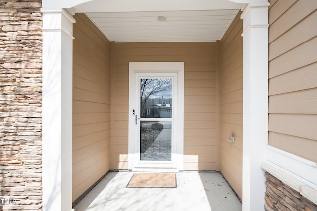 view of exterior entry featuring stone siding