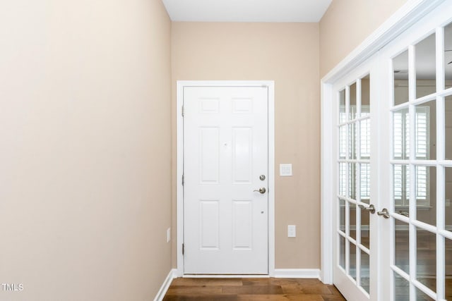 doorway to outside with dark wood-style flooring, french doors, and baseboards