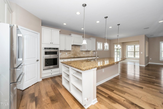 kitchen with open shelves, backsplash, appliances with stainless steel finishes, white cabinets, and wood finished floors