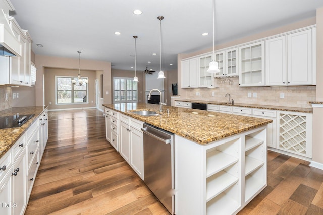 kitchen with dishwasher, tasteful backsplash, a sink, and white cabinetry