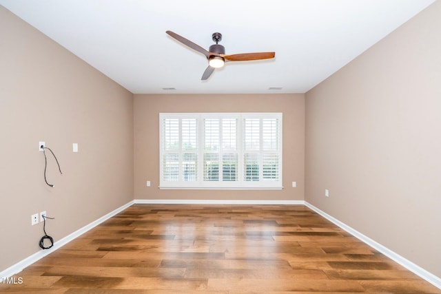 unfurnished room featuring visible vents, baseboards, ceiling fan, and wood finished floors