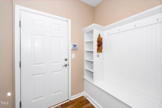 mudroom with dark wood-type flooring and baseboards