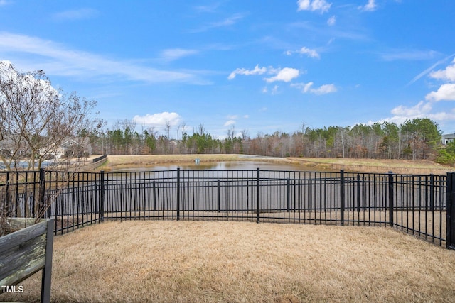 view of yard featuring a water view and fence