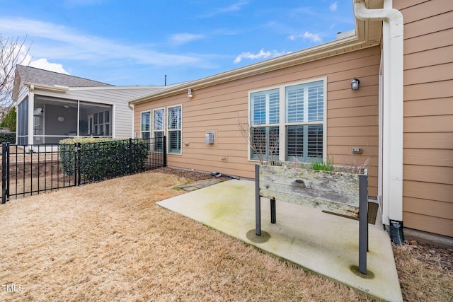 back of house with fence and a sunroom