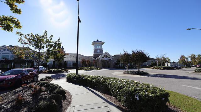 view of road featuring sidewalks, street lighting, and a residential view