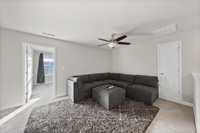 carpeted living room with ceiling fan