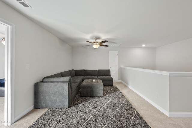 carpeted living room with ceiling fan