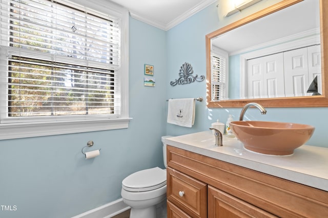 bathroom with vanity, crown molding, and toilet