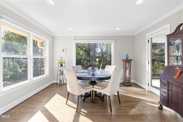 dining area with crown molding and light wood-type flooring