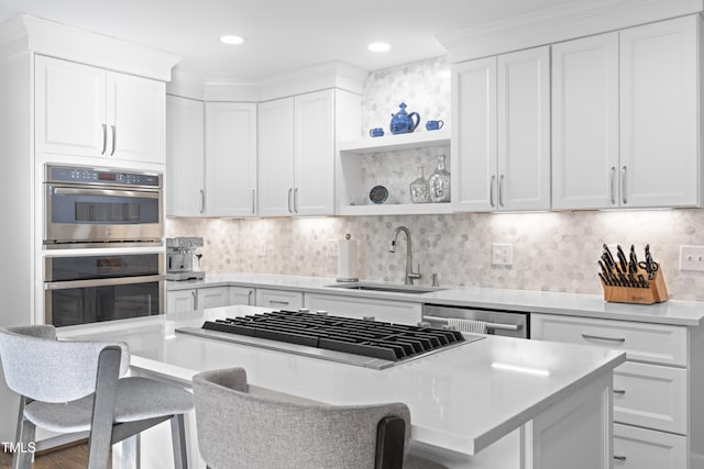 kitchen featuring a kitchen bar, sink, and white cabinets