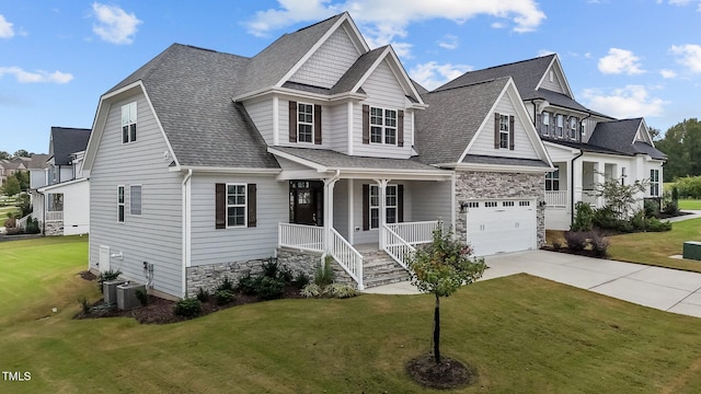 view of front facade with cooling unit, a garage, a front yard, and a porch