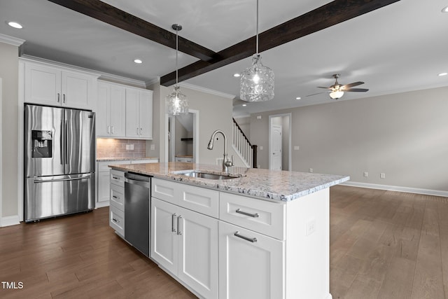 kitchen with sink, an island with sink, white cabinets, and appliances with stainless steel finishes