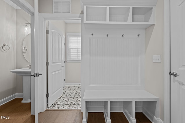 mudroom with wood-type flooring