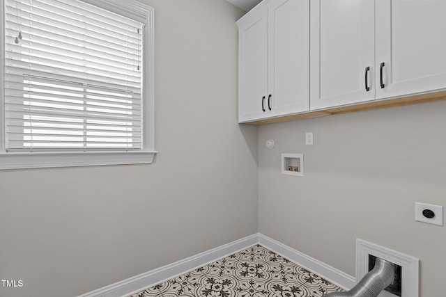 clothes washing area with cabinets, washer hookup, tile patterned flooring, and electric dryer hookup