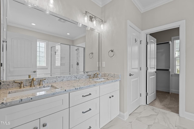 bathroom with crown molding, plenty of natural light, vanity, and a shower with shower door