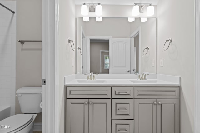 full bathroom featuring vanity, washtub / shower combination, and toilet