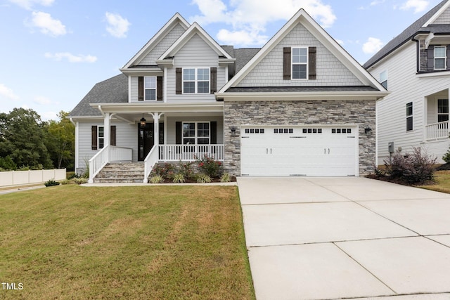 craftsman house featuring a garage, a front yard, and covered porch