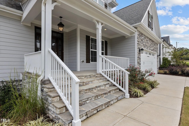 property entrance featuring a garage and a porch