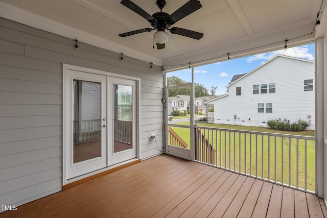 unfurnished sunroom featuring ceiling fan