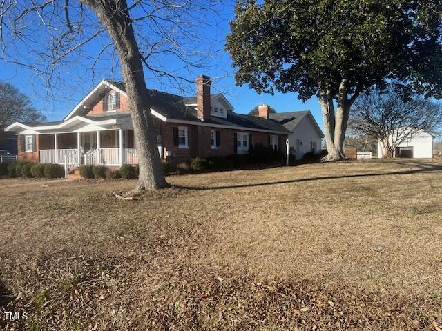 exterior space with a yard and covered porch