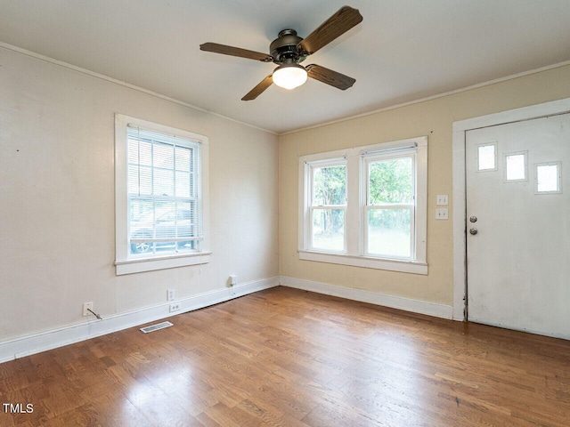 foyer entrance featuring crown molding, hardwood / wood-style floors, and ceiling fan