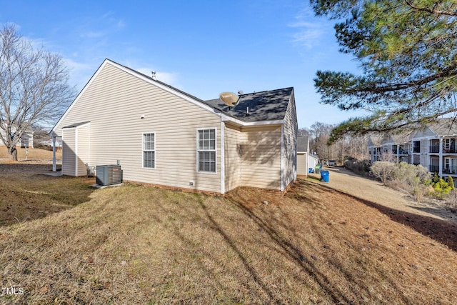 view of home's exterior with central AC and a lawn