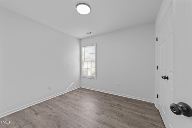 empty room with wood-type flooring