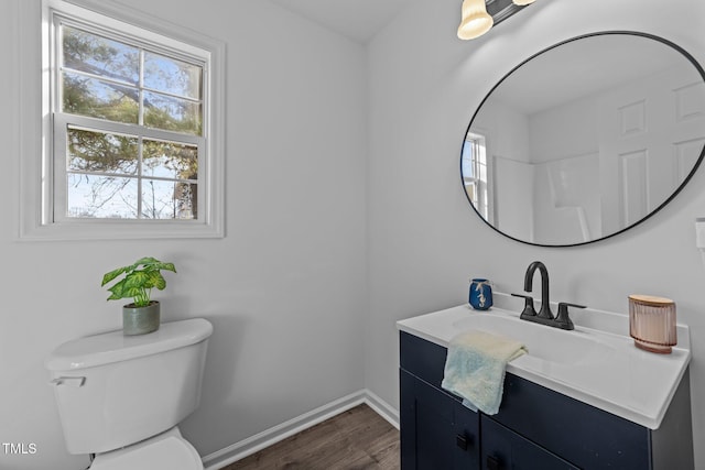 bathroom featuring vanity, hardwood / wood-style floors, and toilet