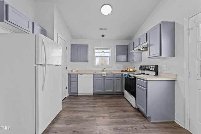 kitchen with gray cabinetry, sink, white appliances, and decorative light fixtures