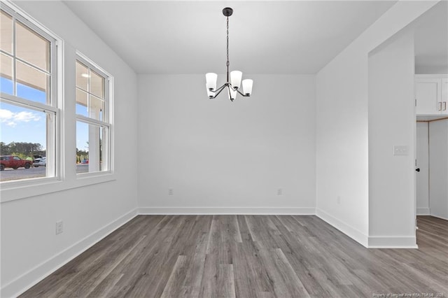 531 Southerland Peak, Raeford, NC 28376 - unfurnished dining area with baseboards, wood finished floors, and an inviting chandelier