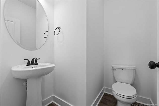 531 Southerland Peak, Raeford, NC 28376 - bathroom featuring baseboards, toilet, and wood finished floors