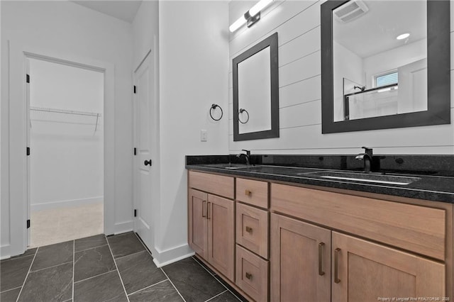 531 Southerland Peak, Raeford, NC 28376 - full bathroom with a walk in closet, visible vents, a sink, and double vanity