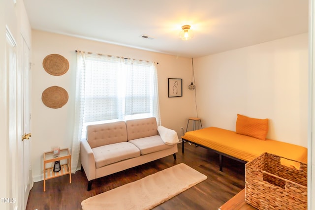 living room with dark hardwood / wood-style flooring