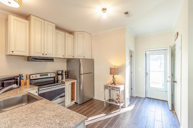 kitchen featuring sink, ornamental molding, stainless steel appliances, and white cabinets