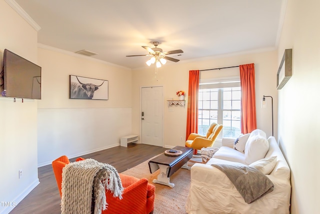 living room with ornamental molding, dark hardwood / wood-style floors, and ceiling fan