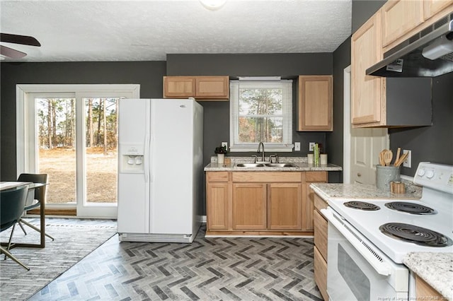 kitchen with sink, white appliances, a textured ceiling, ceiling fan, and light stone countertops