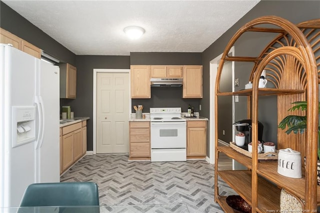 kitchen with light brown cabinets, a textured ceiling, and white appliances