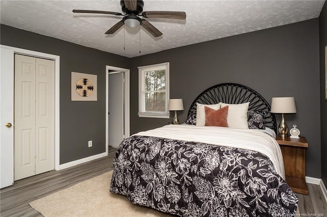 bedroom featuring a closet, ceiling fan, hardwood / wood-style floors, and a textured ceiling