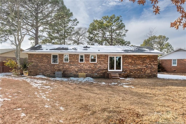 snow covered house featuring central air condition unit