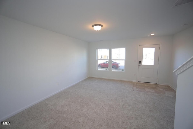 spare room with light colored carpet