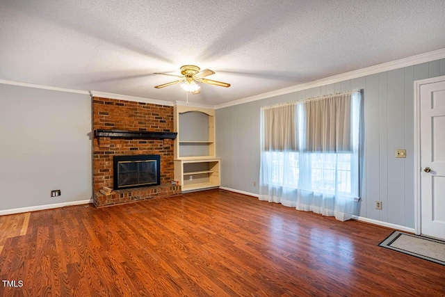 unfurnished living room with hardwood / wood-style flooring, crown molding, a textured ceiling, and a fireplace