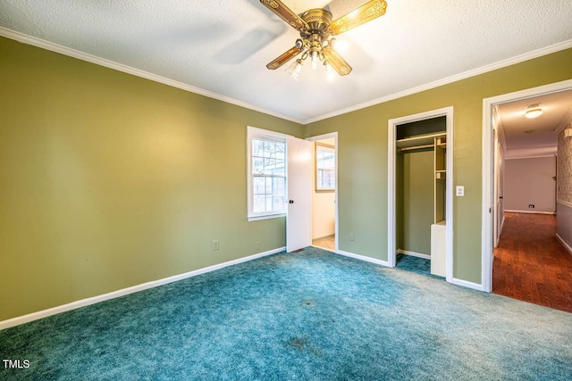 unfurnished bedroom featuring ornamental molding, carpet flooring, a closet, and a textured ceiling