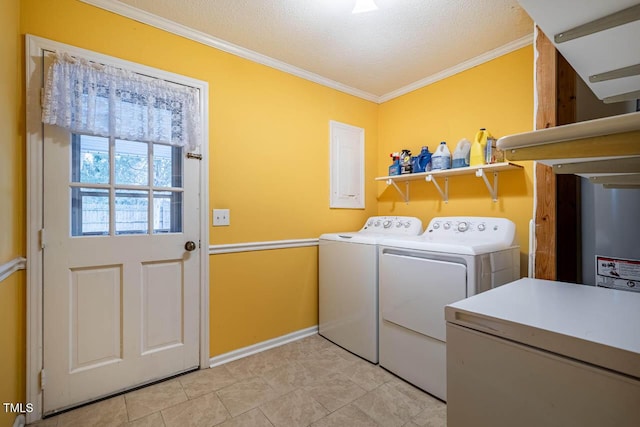 washroom featuring ornamental molding, washing machine and dryer, and a textured ceiling