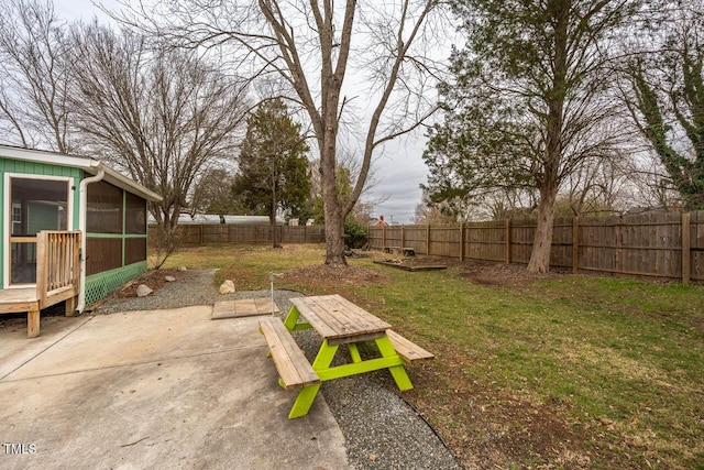 view of yard featuring a sunroom and a patio