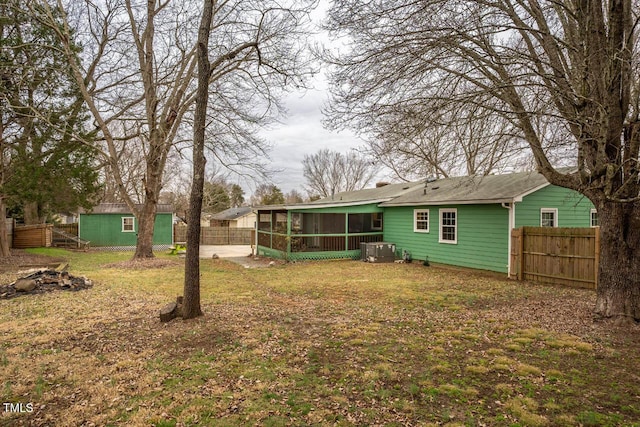 view of yard featuring central AC unit and a sunroom