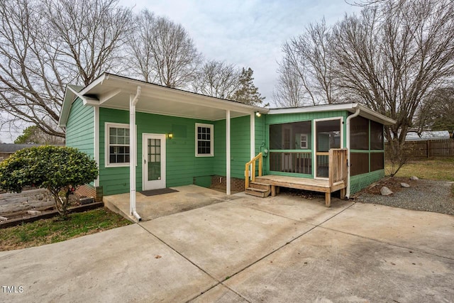 rear view of property with a sunroom