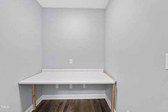 mudroom featuring dark wood-style floors and baseboards