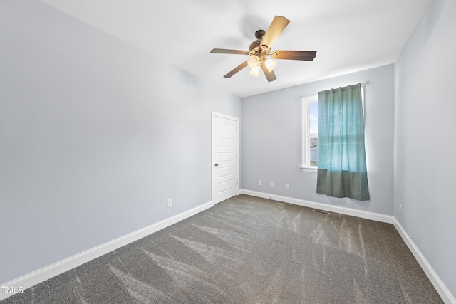 empty room featuring a ceiling fan, carpet, visible vents, and baseboards