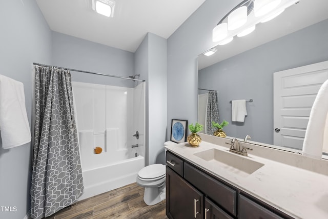 full bathroom featuring shower / bath combination with curtain, vanity, wood finished floors, and toilet