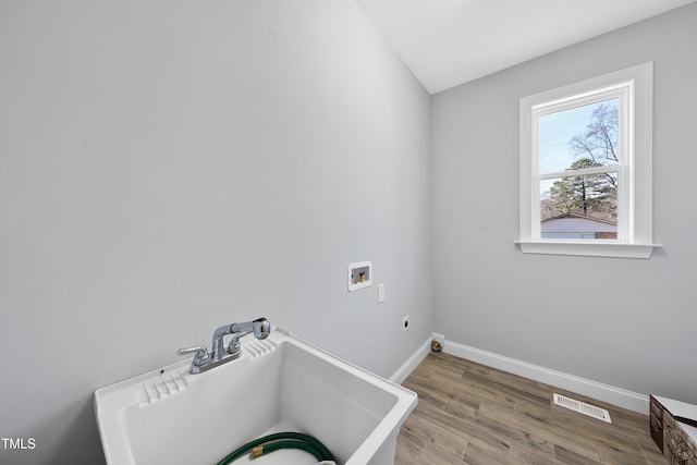 clothes washing area with laundry area, baseboards, visible vents, washer hookup, and electric dryer hookup